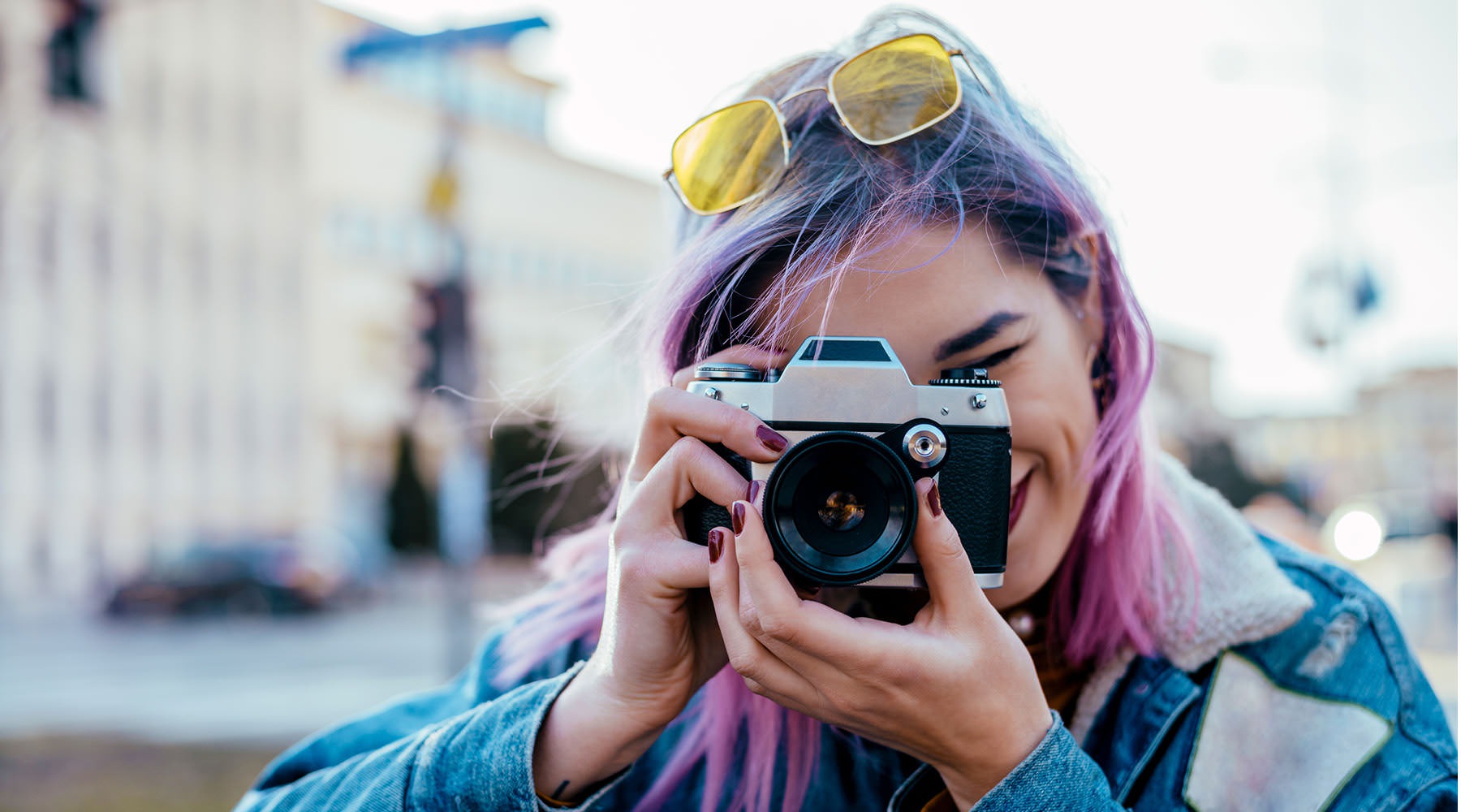 Feel at Home woman with pink hair takes a picture