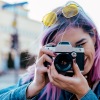 woman with pink hair takes a picture